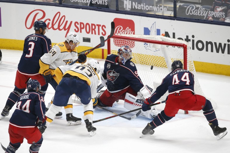 May 3, 2021; Columbus, Ohio, USA; Columbus Blue Jackets goalie Elvis Merzlikins (90) looks back as the shot from Nashville Predators center Ryan Johansen (92) goes in to the goal during the second period at Nationwide Arena. Mandatory Credit: Russell LaBounty-USA TODAY Sports