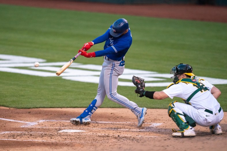 May 3, 2021; Oakland, California, USA; Toronto Blue Jays right fielder Cavan Biggio (8) hits a single during the third inning against the Oakland Athletics at RingCentral Coliseum. Mandatory Credit: Neville E. Guard-USA TODAY Sports