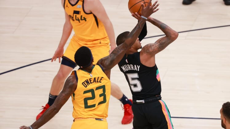 May 3, 2021; Salt Lake City, Utah, USA;  Utah Jazz forward Royce O'Neale (23) blocks the shot of San Antonio Spurs guard Dejounte Murray (5) during the second quarter at Vivint Arena. Mandatory Credit: Chris Nicoll-USA TODAY Sports