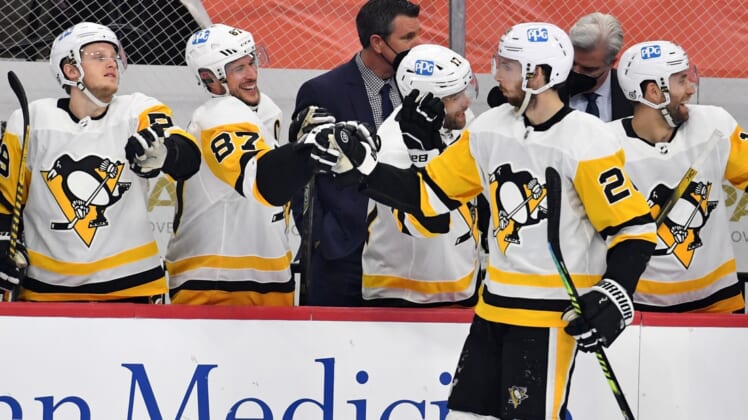 May 4, 2021; Philadelphia, Pennsylvania, USA; Pittsburgh Penguins defenseman Marcus Pettersson (28) celebrates his goal with center Sidney Crosby (87) and left wing Jake Guentzel (59) against the Philadelphia Flyers during the first period at Wells Fargo Center. Mandatory Credit: Eric Hartline-USA TODAY Sports