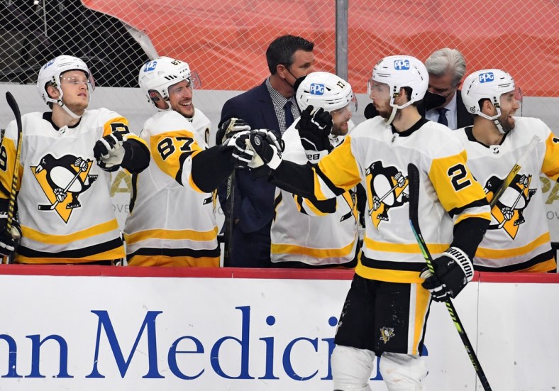 May 4, 2021; Philadelphia, Pennsylvania, USA; Pittsburgh Penguins defenseman Marcus Pettersson (28) celebrates his goal with center Sidney Crosby (87) and left wing Jake Guentzel (59) against the Philadelphia Flyers during the first period at Wells Fargo Center. Mandatory Credit: Eric Hartline-USA TODAY Sports