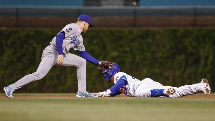 May 4, 2021; Chicago, Illinois, USA; Chicago Cubs third baseman Kris Bryant (17) is safe at second base after hitting a double as Los Angeles Dodgers second baseman Gavin Lux (9) applies a late tag during the third inning of the second game of a doubleheader at Wrigley Field. Mandatory Credit: Kamil Krzaczynski-USA TODAY Sports