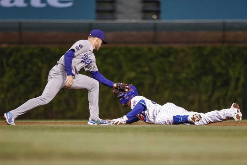 May 4, 2021; Chicago, Illinois, USA; Chicago Cubs third baseman Kris Bryant (17) is safe at second base after hitting a double as Los Angeles Dodgers second baseman Gavin Lux (9) applies a late tag during the third inning of the second game of a doubleheader at Wrigley Field. Mandatory Credit: Kamil Krzaczynski-USA TODAY Sports