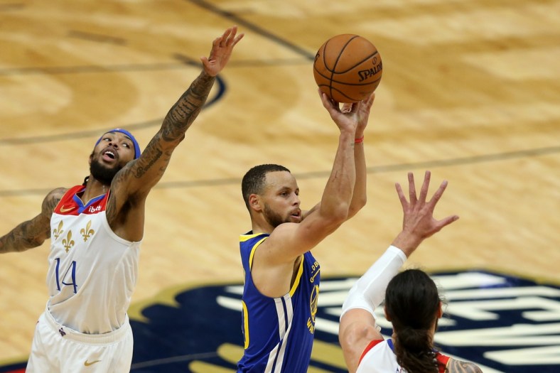 May 4, 2021; New Orleans, Louisiana, USA; Golden State Warriors guard Stephen Curry (30) shoots while defended by  New Orleans Pelicans forward Brandon Ingram (14) and center Steven Adams (12) in the second quarter at the Smoothie King Center. Mandatory Credit: Chuck Cook-USA TODAY Sports