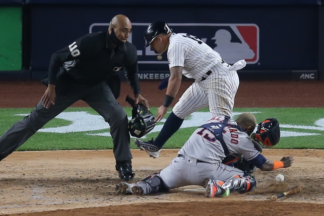 May 4, 2021; Bronx, New York, USA; New York Yankees second baseman Rougned Odor (18) collides with Houston Astros catcher Martin Maldonado (15) while scoring on a hit by Yankees first baseman DJ LeMahieu (not pictured) during the sixth inning at Yankee Stadium. Mandatory Credit: Brad Penner-USA TODAY Sports