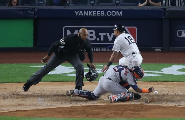 May 4, 2021; Bronx, New York, USA; New York Yankees second baseman Rougned Odor (18) collides with Houston Astros catcher Martin Maldonado (15) while scoring on a hit by Yankees first baseman DJ LeMahieu (not pictured) during the sixth inning at Yankee Stadium. Mandatory Credit: Brad Penner-USA TODAY Sports