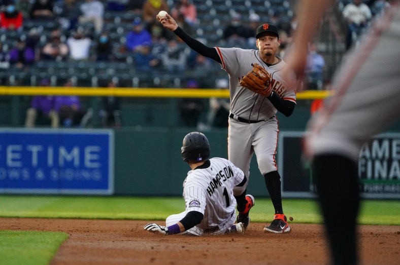 May 4, 2021; Denver, Colorado, USA; San Francisco Giants second baseman Wilmer Flores (41) attempts to turn a double play over Colorado Rockies second baseman Garrett Hampson (1) in the first inning against the at Coors Field. Mandatory Credit: Ron Chenoy-USA TODAY Sports