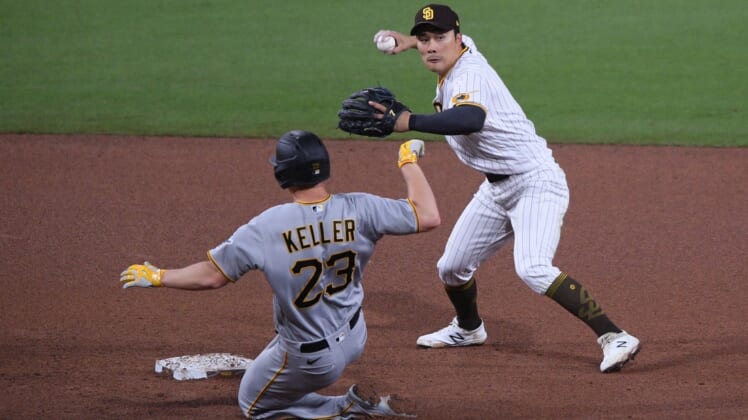 May 4, 2021; San Diego, California, USA; San Diego Padres shortstop Ha-seong Kim (R) throws to first base after forcing out Pittsburgh Pirates starting pitcher Mitch Keller (23) at second base during the fifth inning at Petco Park. Mandatory Credit: Orlando Ramirez-USA TODAY Sports