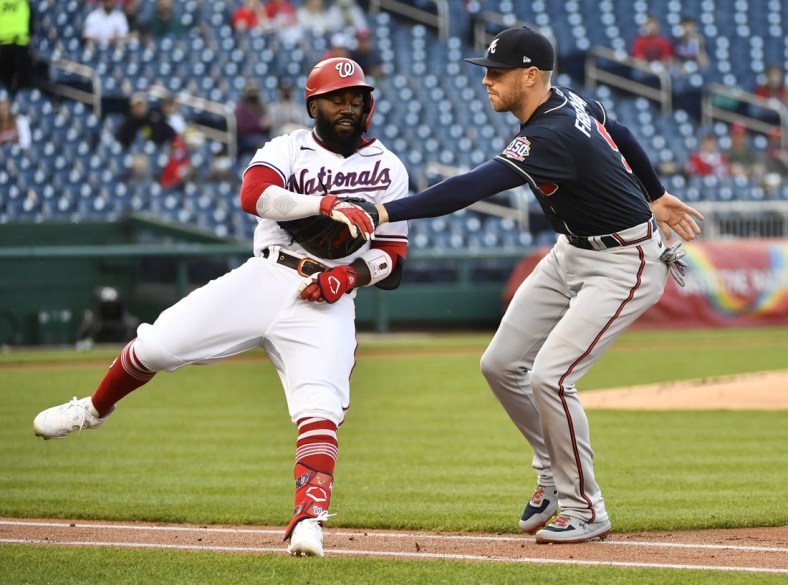 May 5, 2021; Washington, District of Columbia, USA; Washington Nationals second baseman Josh Harrison (5) is tagged out by Atlanta Braves first baseman Freddie Freeman (5) during the first inning at Nationals Park. Mandatory Credit: Brad Mills-USA TODAY Sports