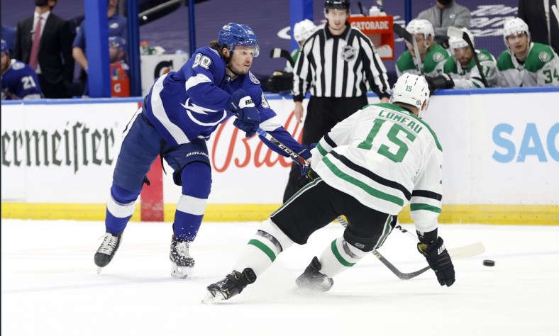 May 5, 2021; Tampa, Florida, USA; Tampa Bay Lightning defenseman Mikhail Sergachev (98) passes the puck as Dallas Stars left wing Blake Comeau (15) defends during the first period at Amalie Arena. Mandatory Credit: Kim Klement-USA TODAY Sports