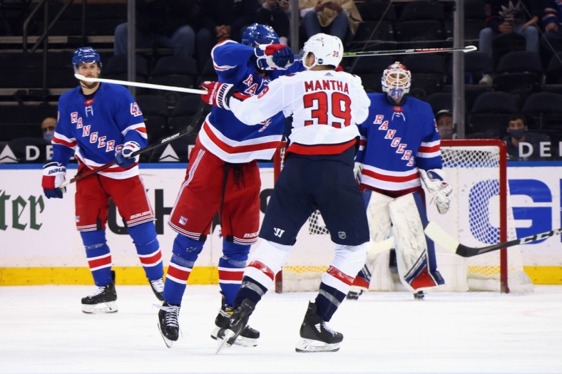 May 5, 2021; New York, New York, USA; Pavel Buchnevich #89 of the New York Rangers takes a high-sticking penalty on Anthony Mantha #39 of the Washington Capitals during the second period at Madison Square Garden. Mandatory Credit:  Bruce Bennett/POOL PHOTOS-USA TODAY Sports