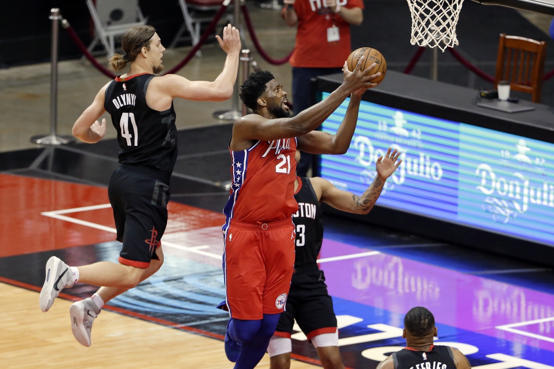 May 5, 2021; Houston, Texas, USA;  Philadelphia 76ers center Joel Embiid (21) gets a shot up past Houston Rockets forward Kelly Olynyk (41) and guard Kevin Porter Jr., right, during the second half at Toyota Center. Mandatory Credit:  Michael Wyke/POOL PHOTOS-USA TODAY Sports