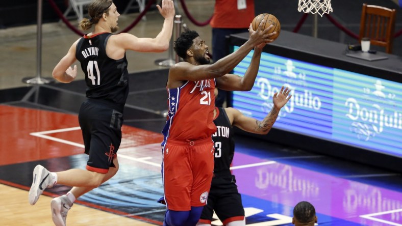 May 5, 2021; Houston, Texas, USA;  Philadelphia 76ers center Joel Embiid (21) gets a shot up past Houston Rockets forward Kelly Olynyk (41) and guard Kevin Porter Jr., right, during the second half at Toyota Center. Mandatory Credit:  Michael Wyke/POOL PHOTOS-USA TODAY Sports