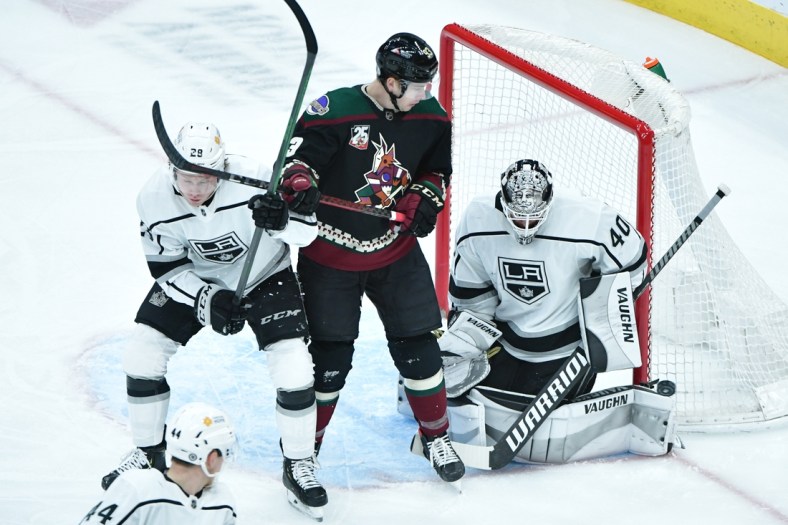 May 5, 2021; Glendale, Arizona, USA; Los Angeles Kings goaltender Calvin Petersen (40) makes a save as Arizona Coyotes center Lane Pederson and center Jaret Anderson-Dolan (28) battle for position during the first period at Gila River Arena. Mandatory Credit: Matt Kartozian-USA TODAY Sports