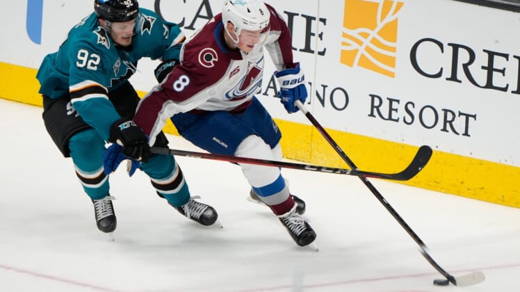 May 5, 2021; San Jose, California, USA;  San Jose Sharks left wing Rudolfs Balcers (92) and Colorado Avalanche defenseman Cale Makar (8) fight for control of the puck during the second period at the SAP Center at San Jose. Mandatory Credit: Stan Szeto-USA TODAY Sports