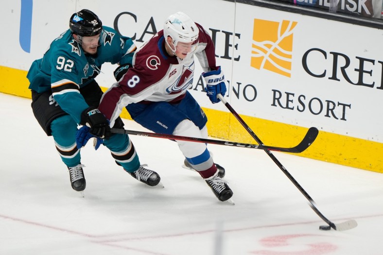 May 5, 2021; San Jose, California, USA;  San Jose Sharks left wing Rudolfs Balcers (92) and Colorado Avalanche defenseman Cale Makar (8) fight for control of the puck during the second period at the SAP Center at San Jose. Mandatory Credit: Stan Szeto-USA TODAY Sports