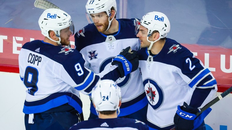 May 5, 2021; Calgary, Alberta, CAN; Winnipeg Jets left wing Adam Lowry (17) celebrates his goal with teammates against the Calgary Flames during the second period at Scotiabank Saddledome. Mandatory Credit: Sergei Belski-USA TODAY Sports