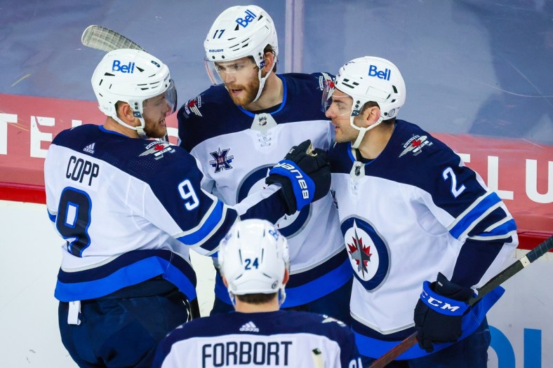 May 5, 2021; Calgary, Alberta, CAN; Winnipeg Jets left wing Adam Lowry (17) celebrates his goal with teammates against the Calgary Flames during the second period at Scotiabank Saddledome. Mandatory Credit: Sergei Belski-USA TODAY Sports
