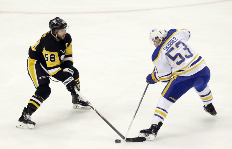 May 6, 2021; Pittsburgh, Pennsylvania, USA;  Pittsburgh Penguins defenseman Kris Letang (58) defends Buffalo Sabres left wing Jeff Skinner (53) during the first period at PPG Paints Arena. Mandatory Credit: Charles LeClaire-USA TODAY Sports