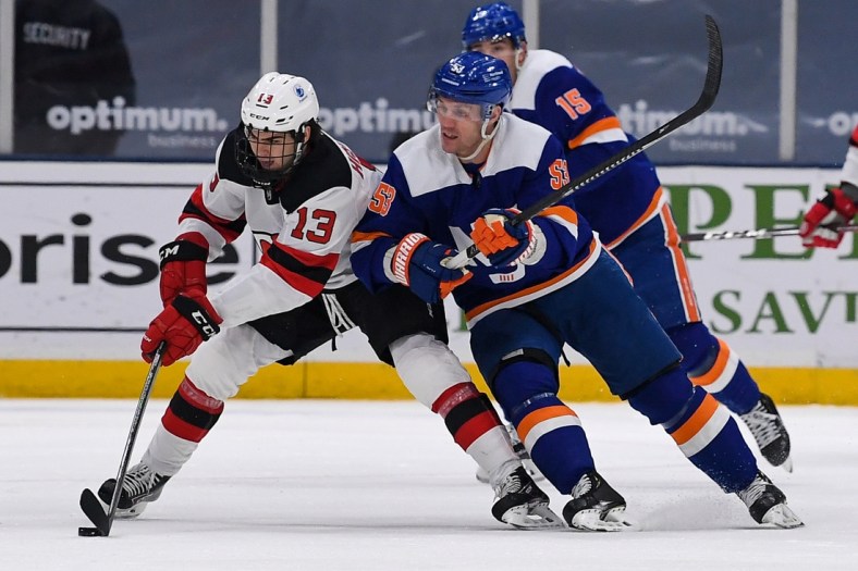 May 6, 2021; Uniondale, New York, USA; New York Islanders center Casey Cizikas (53) defends against New Jersey Devils center Nico Hischier (13) during the first period at Nassau Veterans Memorial Coliseum. Mandatory Credit: Dennis Schneidler-USA TODAY Sports