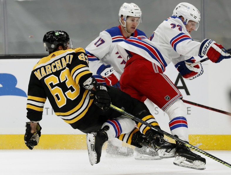 May 6, 2021; Boston, Massachusetts, USA; New York Rangers defenseman Adam Fox (23) collides with Boston Bruins center Brad Marchand (63) during the first period at TD Garden. Mandatory Credit: Winslow Townson-USA TODAY Sports