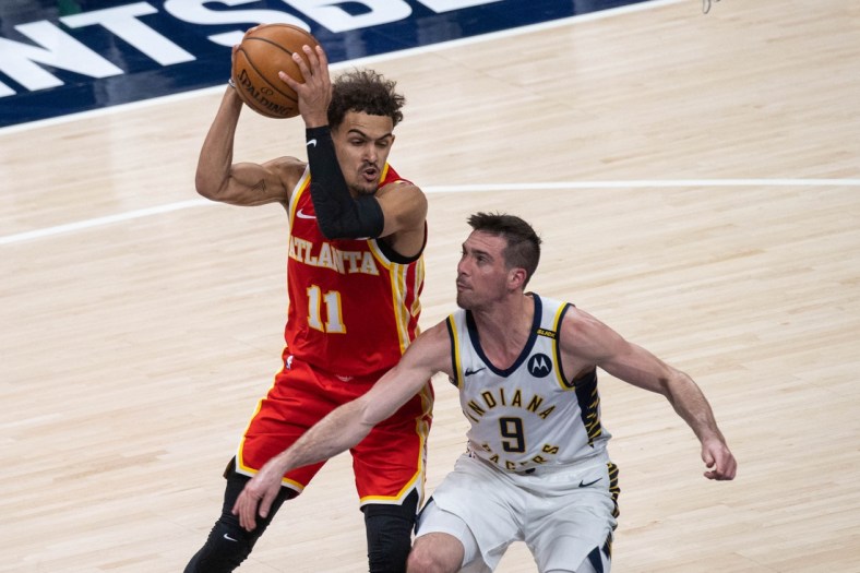 May 6, 2021; Indianapolis, Indiana, USA; Atlanta Hawks guard Trae Young (11) catches the ball while Indiana Pacers guard T.J. McConnell (9) defends in the second quarter at Bankers Life Fieldhouse. Mandatory Credit: Trevor Ruszkowski-USA TODAY Sports