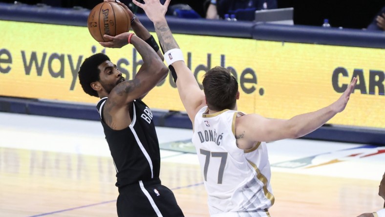 May 6, 2021; Dallas, Texas, USA;  Brooklyn Nets guard Kyrie Irving (11) shoots over Dallas Mavericks guard Luka Doncic (77) during the third quarter at American Airlines Center. Mandatory Credit: Kevin Jairaj-USA TODAY Sports