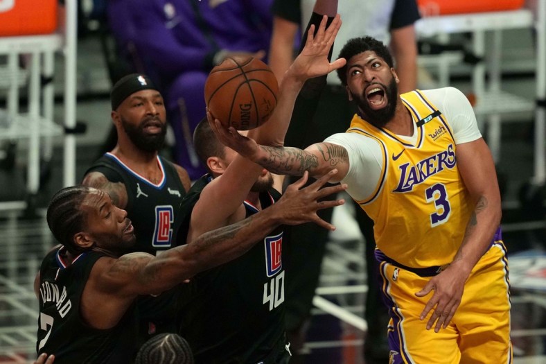 May 6, 2021; Los Angeles, California, USA; Los Angeles Lakers forward Anthony Davis (3) is defended by LA Clippers forward Kawhi Leonard (2) and center Ivica Zubac (40) in the first half at Staples Center. Mandatory Credit: Kirby Lee-USA TODAY Sports
