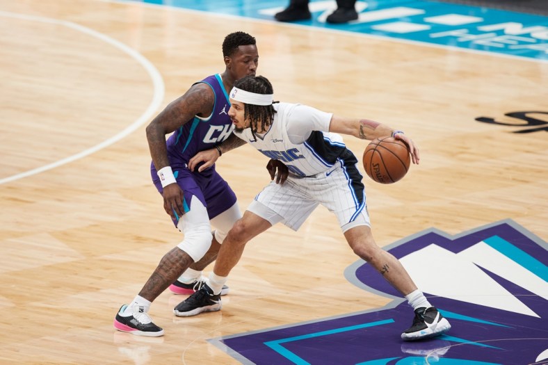 May 7, 2021; Charlotte, North Carolina, USA; Orlando Magic guard Cole Anthony (50) is defended by Charlotte Hornets guard Terry Rozier (3) during first quarter action at Spectrum Center. Mandatory Credit: Brian Westerholt-USA TODAY Sports