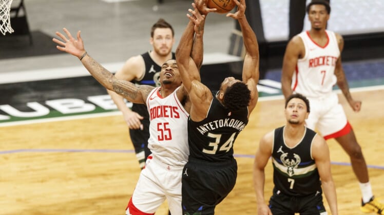 May 7, 2021; Milwaukee, Wisconsin, USA; Houston Rockets guard DaQuan Jeffries (55) and Milwaukee Bucks forward Giannis Antetokounmpo (34) reach for a rebound during the first quarter at Fiserv Forum. Mandatory Credit: Jeff Hanisch-USA TODAY Sports
