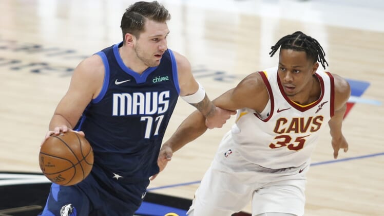 May 7, 2021; Dallas, Texas, USA; Dallas Mavericks guard Luka Doncic (77) drives against Cleveland Cavaliers guard Brodric Thomas (33) during the first quarter at American Airlines Center. Mandatory Credit: Tim Heitman-USA TODAY Sports