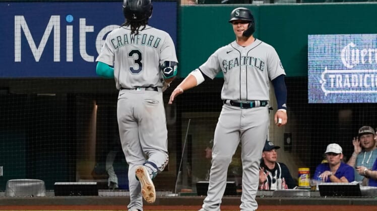 May 7, 2021; Arlington, Texas, USA; Seattle Mariners shortstop J.P. Crawford (3) is greeted by designated hitter Ty France (R) after hitting a two-run home run against the Texas Rangers at Globe Life Field. Mandatory Credit: Jim Cowsert-USA TODAY Sports