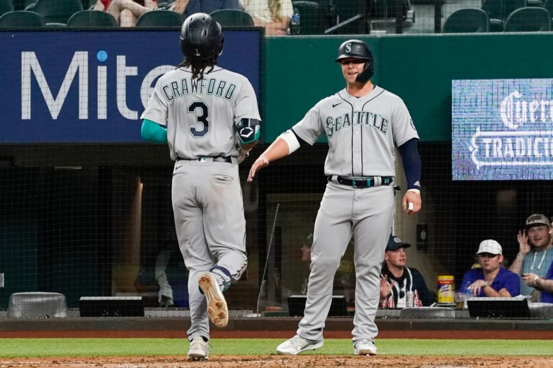 May 7, 2021; Arlington, Texas, USA; Seattle Mariners shortstop J.P. Crawford (3) is greeted by designated hitter Ty France (R) after hitting a two-run home run against the Texas Rangers at Globe Life Field. Mandatory Credit: Jim Cowsert-USA TODAY Sports