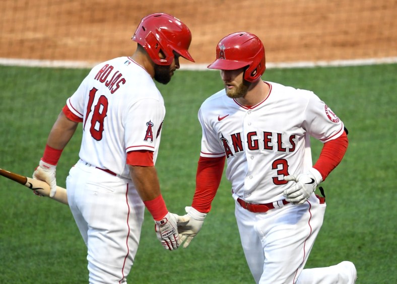May 7, 2021; Anaheim, California, USA; Los Angeles Angels right fielder Taylor Ward (3) is greeted by third baseman Jose Rojas (18) after hitting a solo home run during the second inning against the Los Angeles Dodgers at Angel Stadium. Mandatory Credit: Jayne Kamin-Oncea-USA TODAY Sports