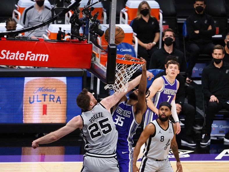 May 7, 2021; Sacramento, California, USA; San Antonio Spurs center Jakob Poeltl (25) reaches in against Sacramento Kings forward Marvin Bagley III (35) during the second quarter at Golden 1 Center. Mandatory Credit: Kelley L Cox-USA TODAY Sports