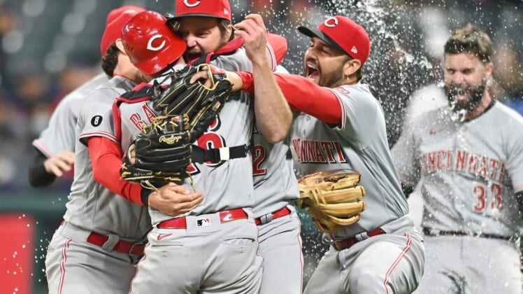 May 7, 2021; Cleveland, Ohio, USA; Cincinnati Reds starting pitcher Wade Miley (22) and catcher Tucker Barnhart (16) and third baseman Eugenio Suarez (7) celebrate after Miley threw a no-hitter against the Cleveland Indians at Progressive Field. Mandatory Credit: Ken Blaze-USA TODAY Sports