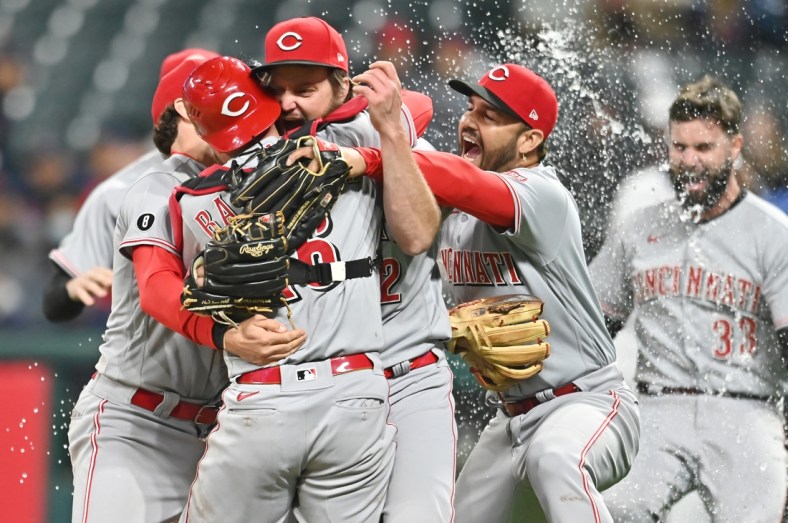 May 7, 2021; Cleveland, Ohio, USA; Cincinnati Reds starting pitcher Wade Miley (22) and catcher Tucker Barnhart (16) and third baseman Eugenio Suarez (7) celebrate after Miley threw a no-hitter against the Cleveland Indians at Progressive Field. Mandatory Credit: Ken Blaze-USA TODAY Sports