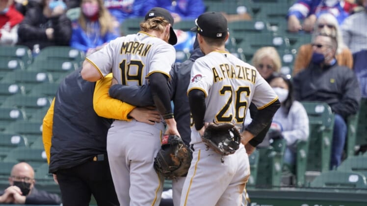 May 8, 2021; Chicago, Illinois, USA; Pittsburgh Pirates first baseman Colin Moran (19) leaves the game after being hurt on a play at first base against the Chicago Cubs during the first inning at Wrigley Field. Mandatory Credit: David Banks-USA TODAY Sports