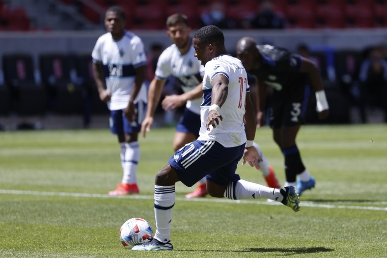 May 8, 2021; Sandy, Utah, CAN; Vancouver Whitecaps forward Cristian Dajome (11) takes a shot to score on a penalty kick in the first half against the CF Montr al at Rio Tinto Stadium. Mandatory Credit: Jeffrey Swinger-USA TODAY Sports