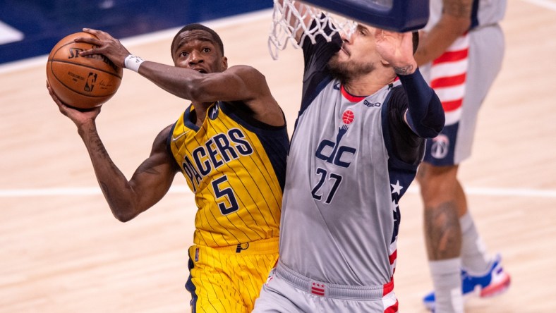 May 8, 2021; Indianapolis, Indiana, USA;  Indiana Pacers guard Edmond Sumner (5) shoots against Washington Wizards center Alex Len (27) during the first half of an NBA basketball game at Bankers Life Fieldhouse. Mandatory Credit: Doug McSchooler-USA TODAY Sports