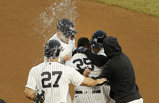 May 8, 2021; Bronx, New York, USA; New York Yankees shortstop Gleyber Torres (25) is congratulated by his teammates after hitting the game winning RBI infield single against the Washington Nationals during the eleventh inning at Yankee Stadium. Mandatory Credit: Andy Marlin-USA TODAY Sports