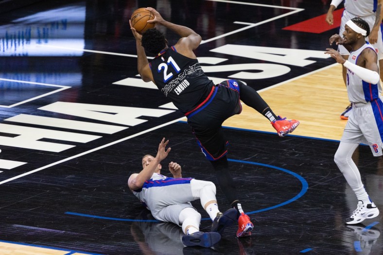 May 8, 2021; Philadelphia, Pennsylvania, USA; Philadelphia 76ers center Joel Embiid (21) collides and fouls Detroit Pistons center Mason Plumlee (24) while driving for a shot during the first quarter at Wells Fargo Center. Mandatory Credit: Bill Streicher-USA TODAY Sports