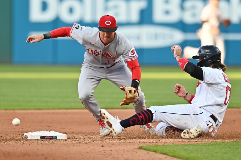 May 8, 2021; Cleveland, Ohio, USA; Cleveland Indians catcher Austin Hedges (right) is safe at second base as Cincinnati Reds shortstop Kyle Farmer (left) cannot handle the throw during the fourth inning at Progressive Field. Mandatory Credit: Ken Blaze-USA TODAY Sports
