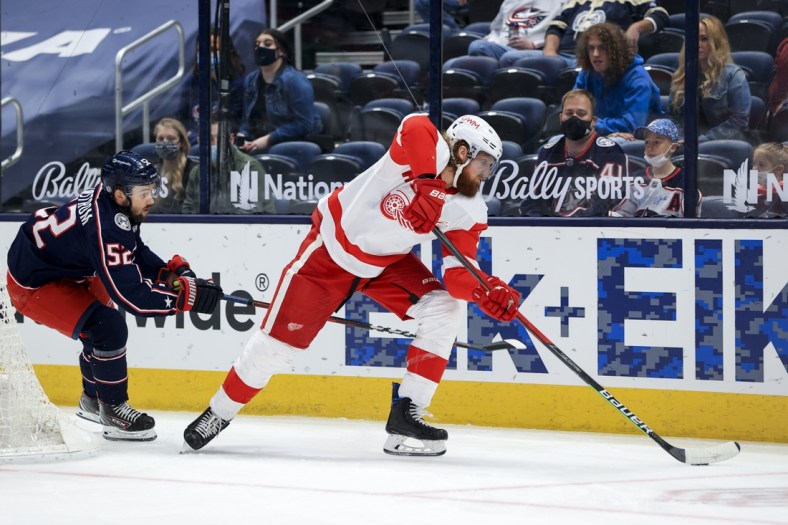 May 8, 2021; Columbus, Ohio, USA; Detroit Red Wings defenseman Marc Staal (18) controls the puck against Columbus Blue Jackets center Emil Bemstrom (52) in the 1st period at Nationwide Arena. Mandatory Credit: Aaron Doster-USA TODAY Sports