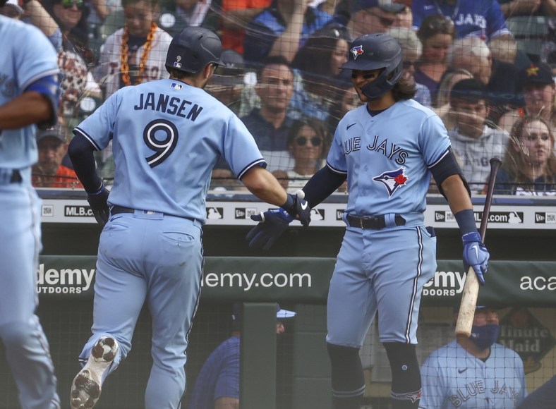 May 8, 2021; Houston, Texas, USA; Toronto Blue Jays catcher Danny Jansen (9) celebrates with shortstop Bo Bichette (11) after hitting a home run against the Houston Astros during the third inning at Minute Maid Park. Mandatory Credit: Troy Taormina-USA TODAY Sports