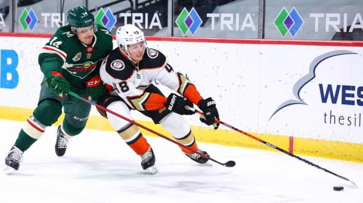 May 8, 2021; Saint Paul, Minnesota, USA; Minnesota Wild center Joel Eriksson Ek (14) and Anaheim Ducks center Isac Lundestrom (48) fight for the puck during the first period at Xcel Energy Center. Mandatory Credit: Harrison Barden-USA TODAY Sports