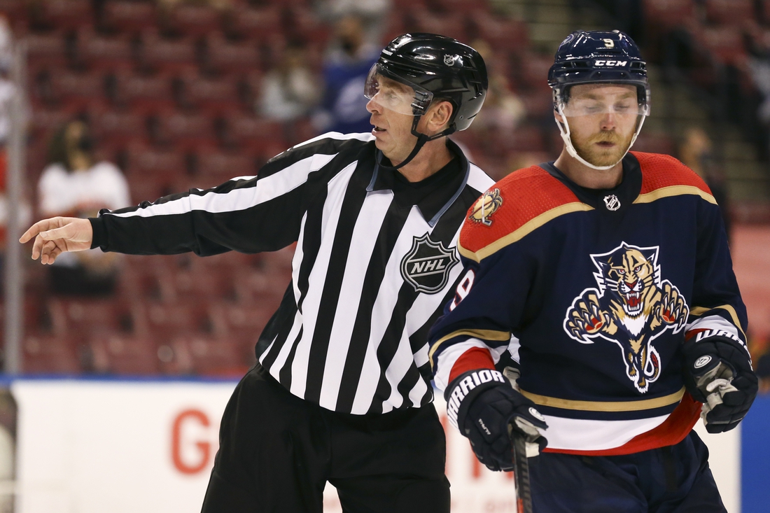 May 8, 2021; Sunrise, Florida, USA; linesman Pierre Racicot (65) skates alongside Florida Panthers center Sam Bennett (9) during the second period at BB&T Center. Mandatory Credit: Sam Navarro-USA TODAY Sports