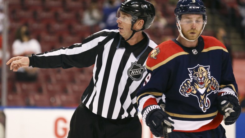 May 8, 2021; Sunrise, Florida, USA; linesman Pierre Racicot (65) skates alongside Florida Panthers center Sam Bennett (9) during the second period at BB&T Center. Mandatory Credit: Sam Navarro-USA TODAY Sports