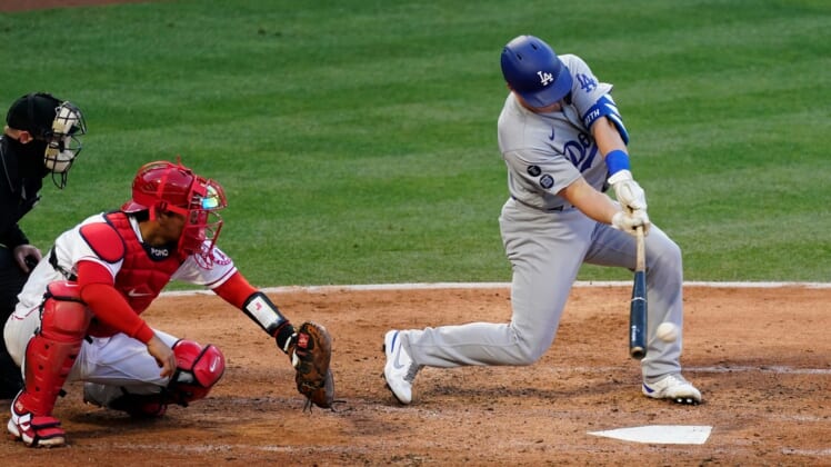 May 8, 2021; Anaheim, California, USA; Los Angeles Dodgers designated hitter Will Smith (16) hits a two run RBI single in the fourth inning against the Los Angeles Angels at Angel Stadium. Mandatory Credit: Robert Hanashiro-USA TODAY Sports