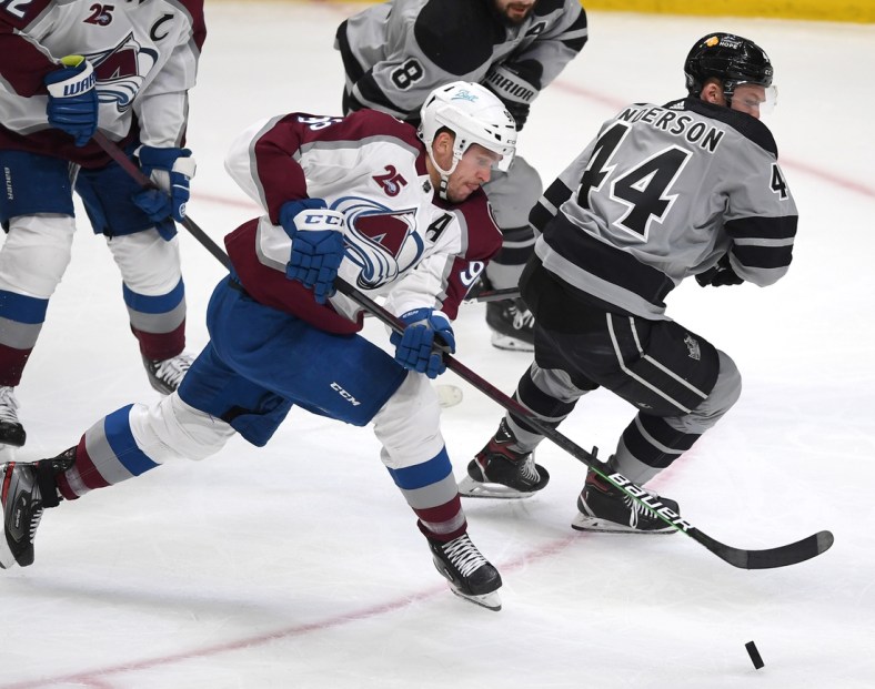 May 8, 2021; Los Angeles, California, USA;  Colorado Avalanche right wing Mikko Rantanen (96) and Los Angeles Kings defenseman Mikey Anderson (44) battle for the puck in the first period of the game at Staples Center. Mandatory Credit: Jayne Kamin-Oncea-USA TODAY Sports